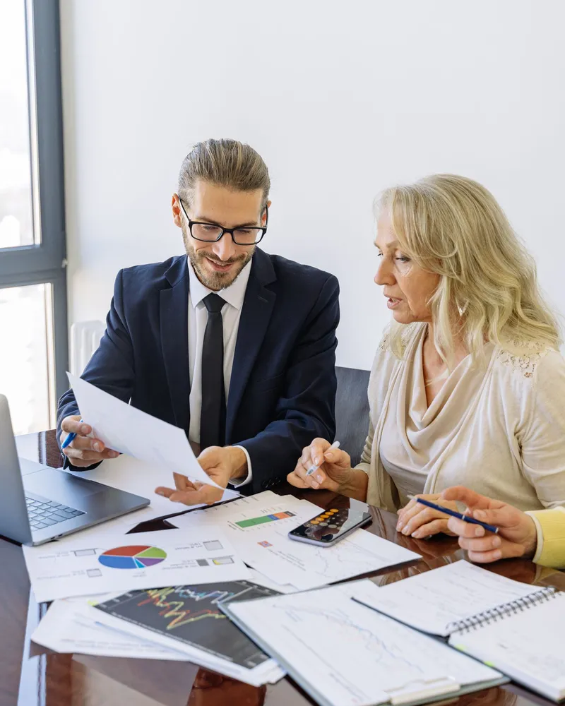 Two people talking through a business plan