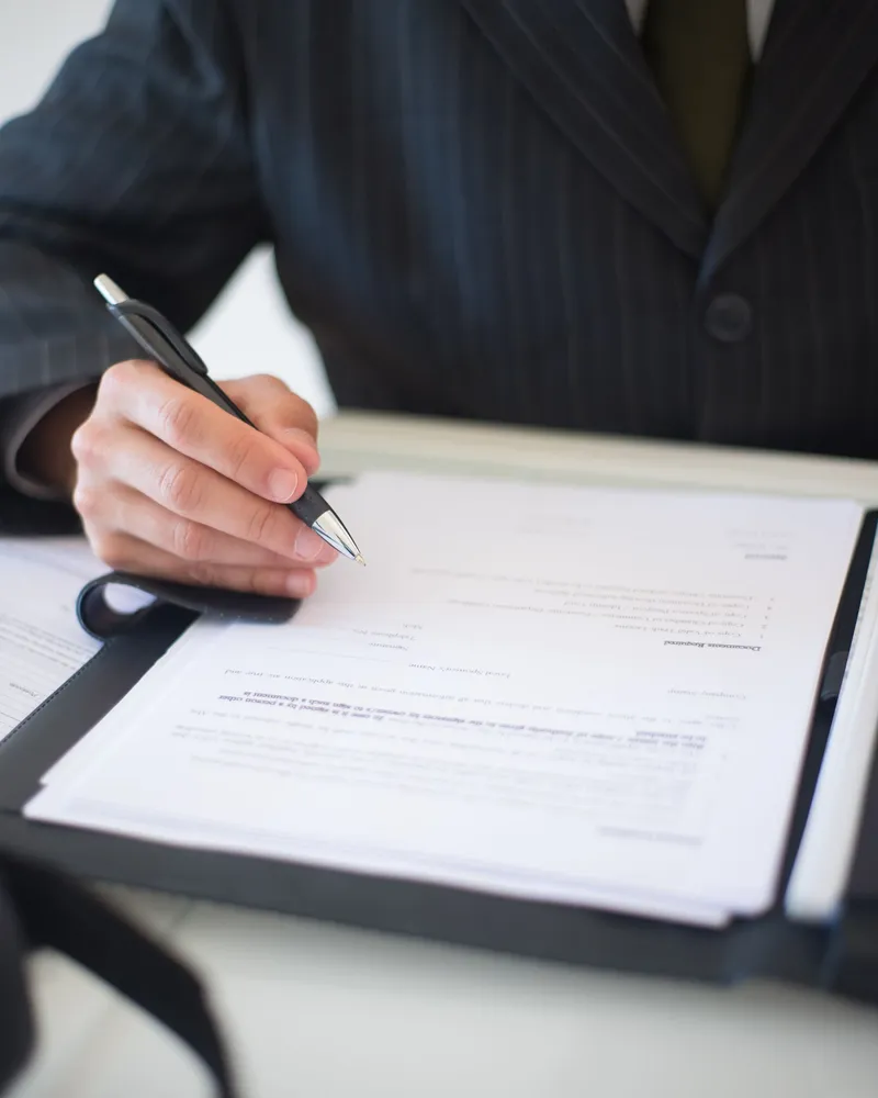 A founder signing company incorporation documents